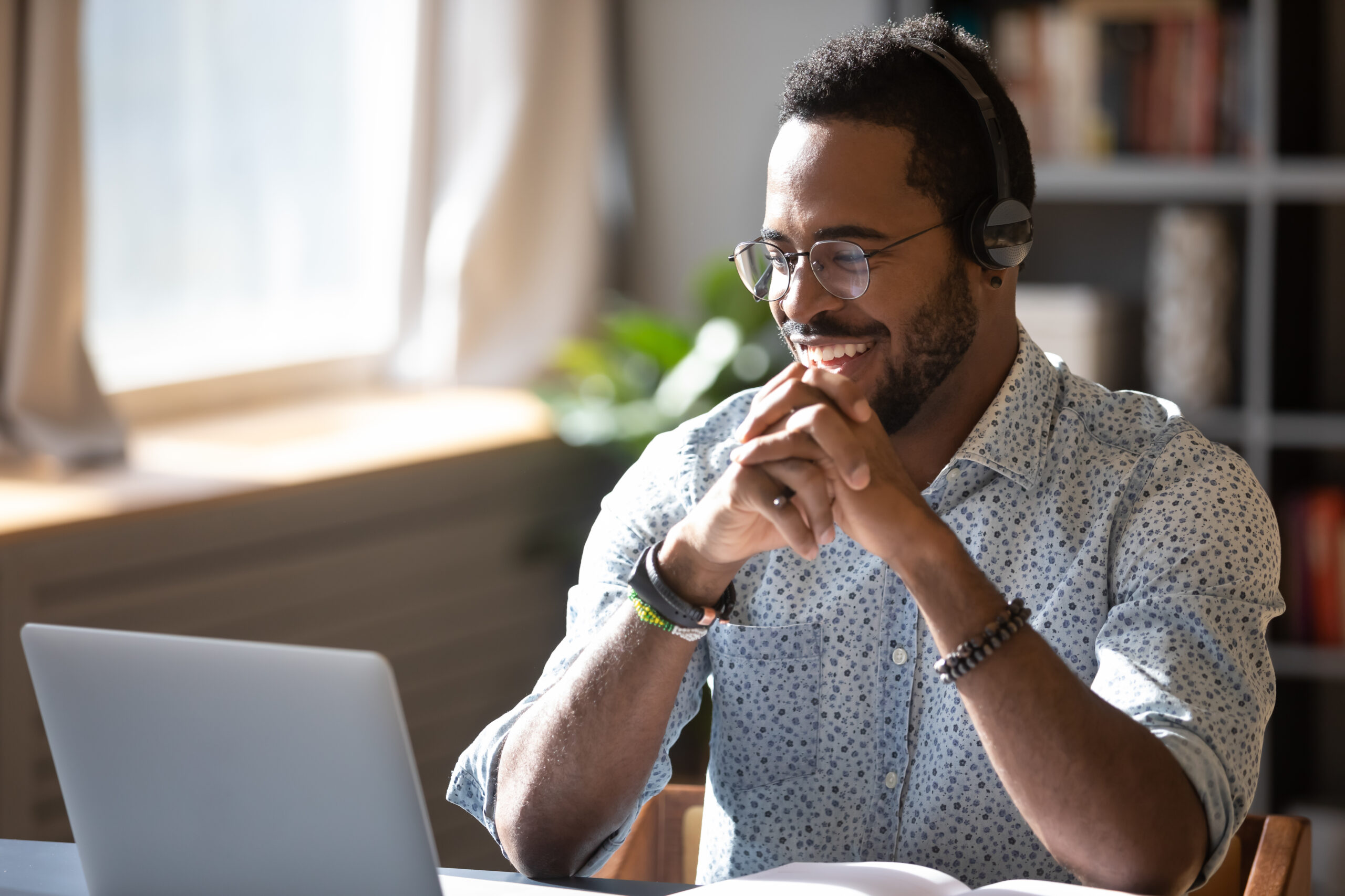 Man works from home on laptop; his company has prioritized cybersecurity to keep him and his clients safe.