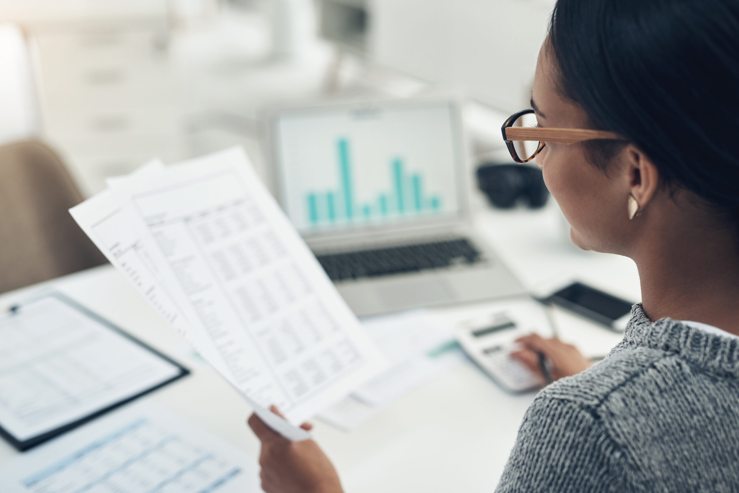 A woman with glasses reviews a clean audit performed for a nonprofit organization